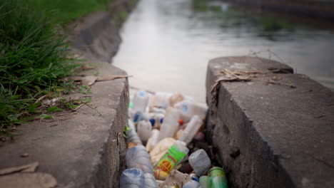 Plastic-containers-clogging-waterway-systems,-waste-contamination,-reveal