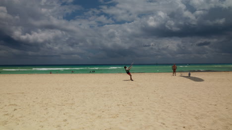 Paraglider-is-taking-off-from-the-sandy-beach-of-Playa-del-Carmen,-Mexico