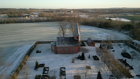 Aerial-of-church-at-sunset-in-winter