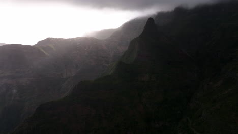 Aerial-view-flying-over-hazy-mountains,-with-dramatic-dark-clouds-in-Madeira