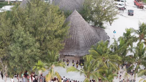 Aerial-view-looking-down-at-athletic-dancing-performance-on-Zanzibar-Machamvi-Kae-beach-festival