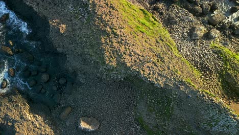 Aerial-shot-of-the-basalt-stones-at-Giant's-Causeway,-County-Antrim-in-Northern-Ireland-at-sunrise