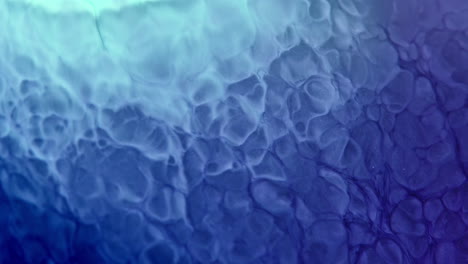 Swirling-blue-ink-creates-mesmerizing-patterns-underwater-in-a-close-up-shot