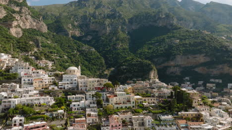 Aerial:-Backwards-reveal-shot-of-Positano-on-Amalfi,-Italy-coast-on-a-sunny-day