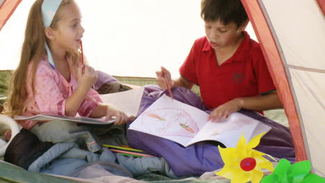 Two-children-in-tent-playing