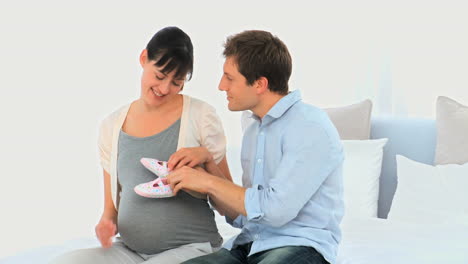 Cute-couple-playing-with-baby-shoes