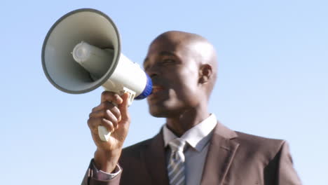 Africanamerican-businessman-screaming-instruction-though-a-megaphone