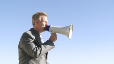 Businessman-giving-instruction-through-a-megaphone