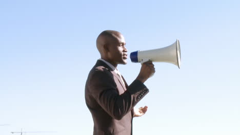 Africanamerican-businessman-giving-instruction-via-megaphone