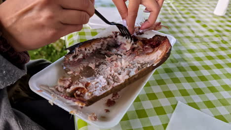 Grilled-Fish-Being-Eaten-on-a-White-Plate-with-Fork