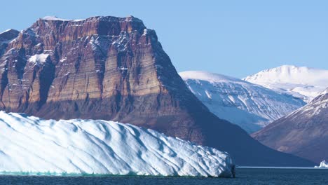 Stunning-Landscape-of-Greenland,-Iceberg,-Limestone-Cliffs,-Snow-Capped-Peaks-and-Glaciers-on-Sunny-Day