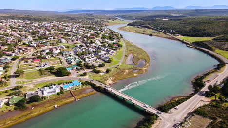 Aerial-view-of-Stilbaai-bridge-with-traffic-and-leisure-crafts-on-Goukou-river