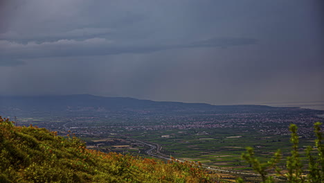 Timelapse-rain-clouds-and-sunbeams-in-a-large-valley-on-the-greek-mainland