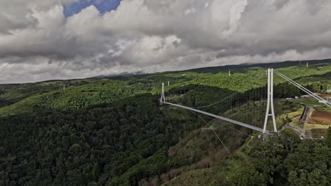 Mishima-Japan-Aerial-v1-cinematic-drone-low-flyover-Sasahara-Shinden-around-Sky-Walk-Bridge-capturing-rolling-hills-landscape-under-a-beautiful-cloud-sky---Shot-with-Mavic-3-Pro-Cine---October-2023