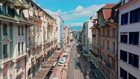 Beautiful-aerial-of-a-calm-street-surrounded-with-historical-buildings-in-the-city-center-of-Geneva,-Switzerland-on-a-sunny-summer-day