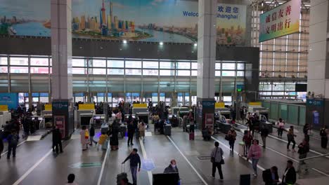 China,-Nanjing:-The-video-captures-the-perspective-of-the-main-hall-of-Nanjing-Station,-highlighting-its-architecture-and-bustling-activity