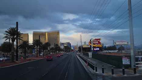 Las-Vegas-USA,-Driving-on-South-Part-of-Strip-in-Twilight-Under-Cloudy-Rainy-Sky