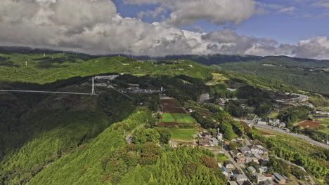 Mishima-Japan-Aerial-v4-drone-flyover-Sasahara-Shinden-capturing-Sky-Walk-Bridge,-quaint-mountain-town,-hillside-farmlands-and-mountainous-landscape---Shot-with-Mavic-3-Pro-Cine---October-2023