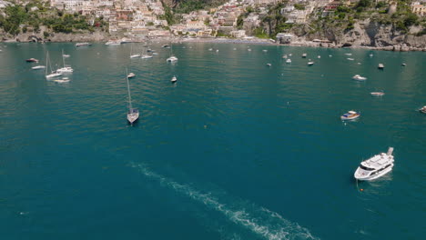 Aerial:-Slow-reveal-shot-of-Positano-in-Amalfi-coast,-Italy-during-a-sunny-day