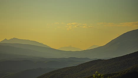 Shades-of-mountains-in-Greek-countryside,-static-time-lapse-with-yellow-tint