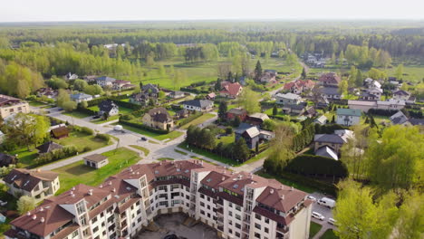 Multi-story-buildings-and-private-estates-in-small-township,-aerial-drone-view