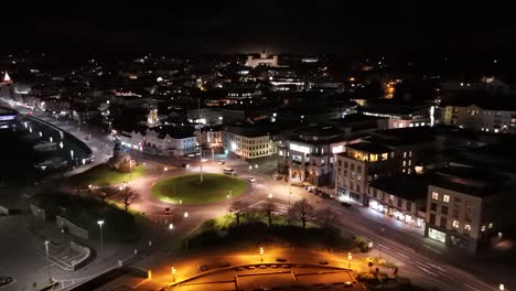 Drone-footage-of-roundabout-St-Julian’s-Avenue-St-Peter-Port-Guernsey-over-North-Beach-and-weighbridge-at-night-with-Elizabeth-College-lit-up-in-the-background
