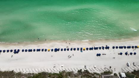 Colorful-Beach-Umbrellas-Lined-On-Sandy-Shore-In-Walton-County,-Florida,-USA