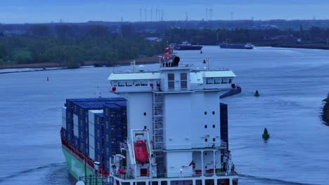 Goods-travelling-on-Dutch-river-to-distribution-destination,-ship-navigation