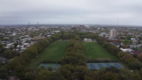 Aerial-wide-reverse-pullback-shot-of-Forsyth-Park-in-Savannah,-Georgia