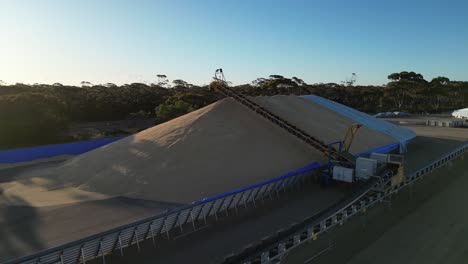 Aerial-orbit-of-grain-pile-transporting-with-pipeline-in-factory-after-harvesting