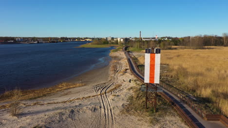 Aerial-View-of-Pärnu-River-and-Lighthouse-on-Golden-Hour