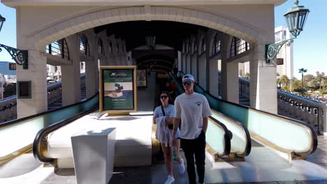 Gente-Caminando-Por-Una-Escalera-Mecánica-Al-Aire-Libre-En-Las-Vegas,-Con-Una-Arquitectura-Elegante-Y-Un-Clima-Soleado.