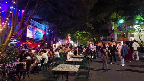 Bustling-nightlife-scene-in-Provenza,-Medellin-with-vibrant-lights-and-lively-crowds