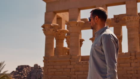 Male-Tourist-Exploring-Ancient-Egyptian-Architecture-at-Trajan's-Kiosk,-Philae-Island