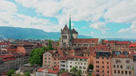 Beautiful-aerial-of-the-Geneva-Cathedral,-Cathédrale-Saint-Pierre-Genève,-surrounded-by-historical-buildings-in-the-city-center