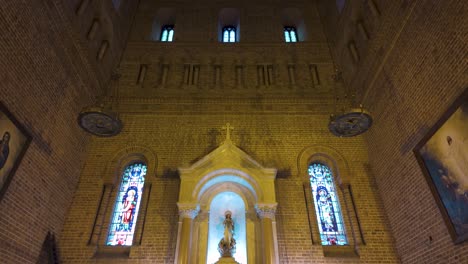 The-interior-of-Catedral-Metropolitana-de-Medellin-with-tall-brick-walls-and-arched-windows