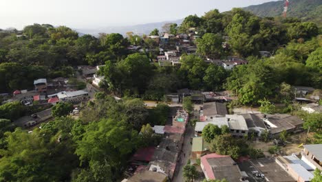 Minca,-colombia,-showcasing-a-lush-green-village-surrounded-by-mountains,-aerial-view
