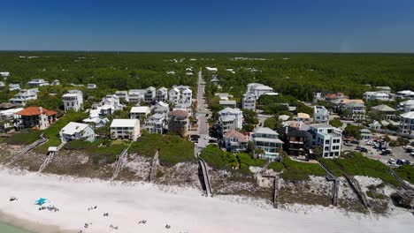 People-On-White-Sand-Beach-With-Beach-Community-In-Background