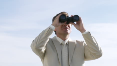 Powerful-businessman-watching-through-binoculas