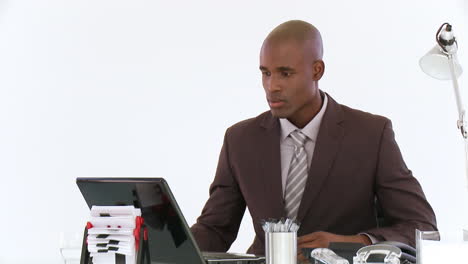 Businessman-concentrating-on-his-laptop