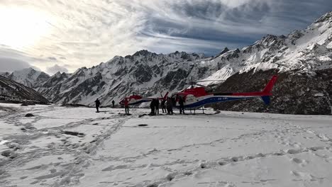 Witness-a-dramatic-helicopter-landing-amidst-snow-flying-around-in-the-High-Alpine-Kyanjin-Gompa-Valley-on-the-Lang-Tang-Trek-in-Nepal’s-Himalayas