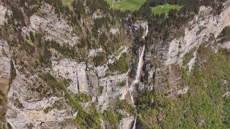 The-cascading-waters-of-Seerenbachfälle-in-Amden-Betlis,-Walensee,-Switzerland,-as-they-gracefully-descend-over-rugged-terrain,-illustrating-the-harmonious-blend-of-nature's-power-and-rugged-beauty