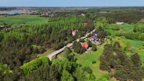 Rural-houses-nestled-among-lush-greenery-and-forests,-distant-from-the-town