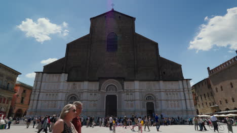 Historic-Basilica-facade-in-Bologna-with-bustling-square