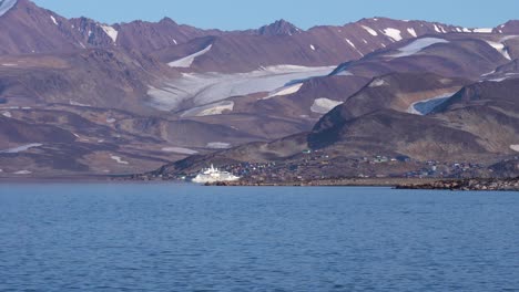 Greenland-Coastline,-Ship-in-Port-of-Ittoqqortoormiit-Village-on-Sunny-Day