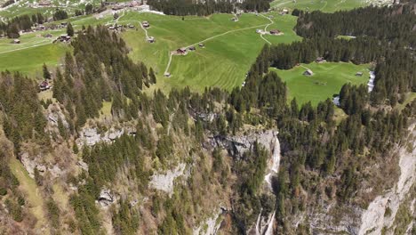 Aerial-of-the-plateau-overlooking-Seerenbachfälle-in-Amden-Betlis,-Walensee,-Switzerland,-epitomizing-a-serene-blend-of-nature's-grandeur-and-tranquil-beauty