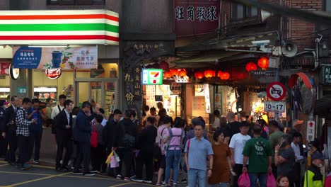 Large-crowd-of-people-at-the-narrow-entrance-of-Jiufen-Old-Street,-a-gold-mining-mountain-town,-a-popular-tourist-attraction-in-Taiwan