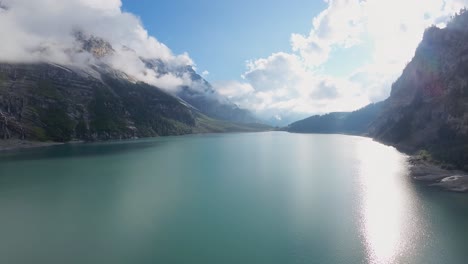 Aerial-flight-over-a-beautiful-big-Oeschinen-lake-on-a-mountain-in-Switzerland