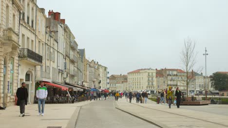 People-walking-on-avenue-in-historical-town-center-in-pedestrian-zone