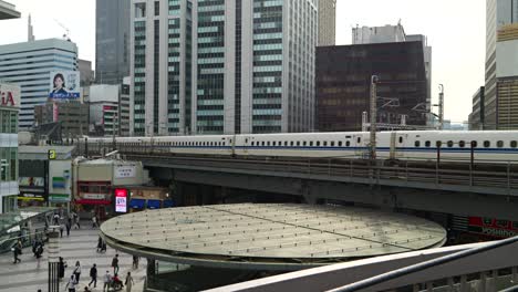Tokaido-Shinkansen-moving-through-streets-of-urban-Tokyo